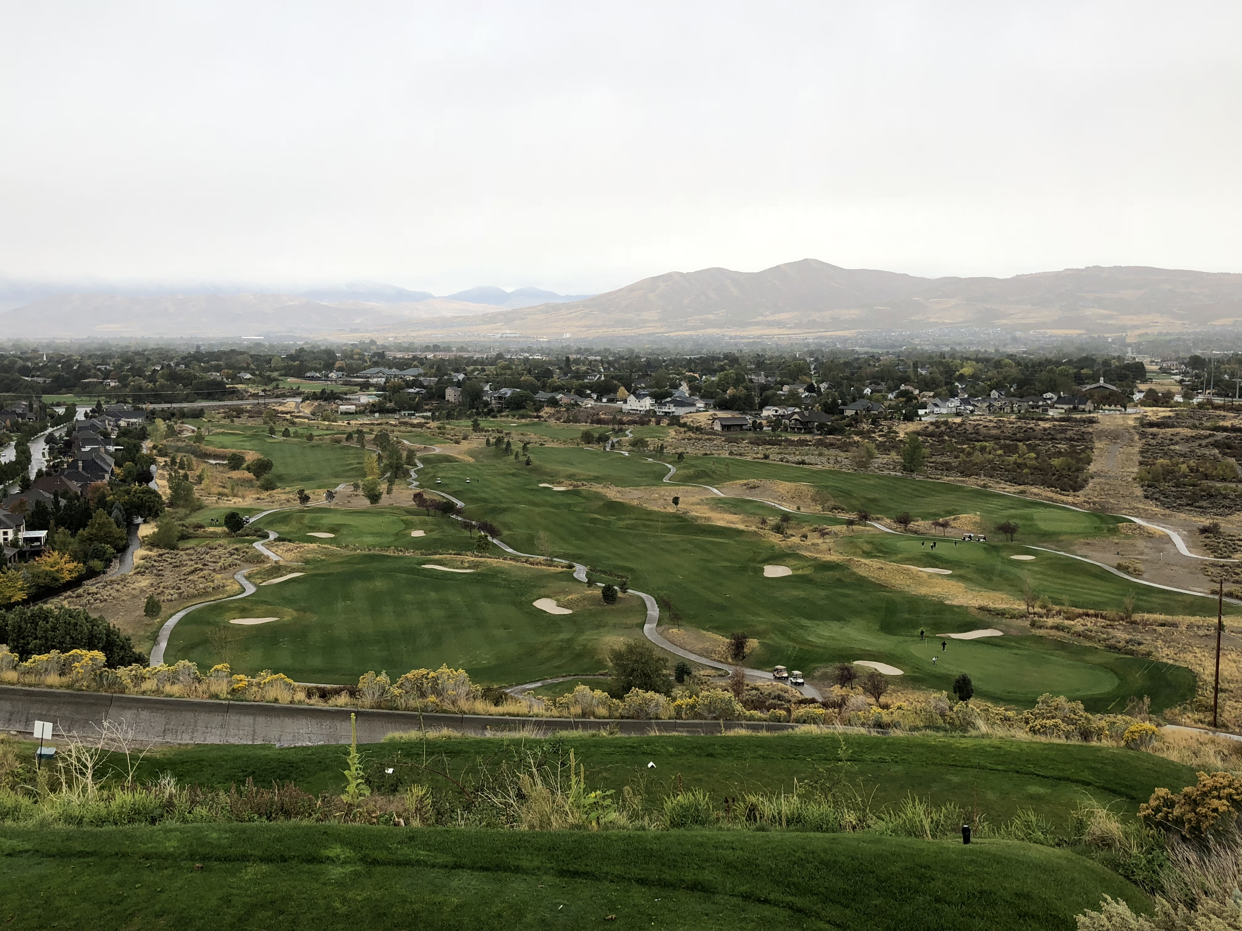 Cedar Hills golf fairways with homes and mountains beyond